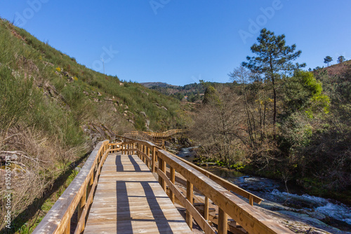 The river hiking trail Ecovia do Vez near Arcos de Valdevez, Portugal. Ecovia do Vez wooden pathways along the riverside. © An Instant of Time