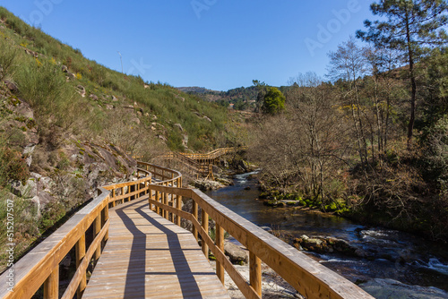 The river hiking trail Ecovia do Vez near Arcos de Valdevez, Portugal. Ecovia do Vez wooden pathways along the riverside.