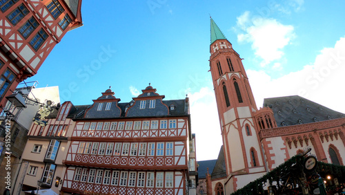 Frankfurt am Main, Germany, December 7, 2021: The Römerberg Square. The historical old town center, including its splendid half-timbered houses and the Alte Nicolaikirche (St Nicholas Church). photo