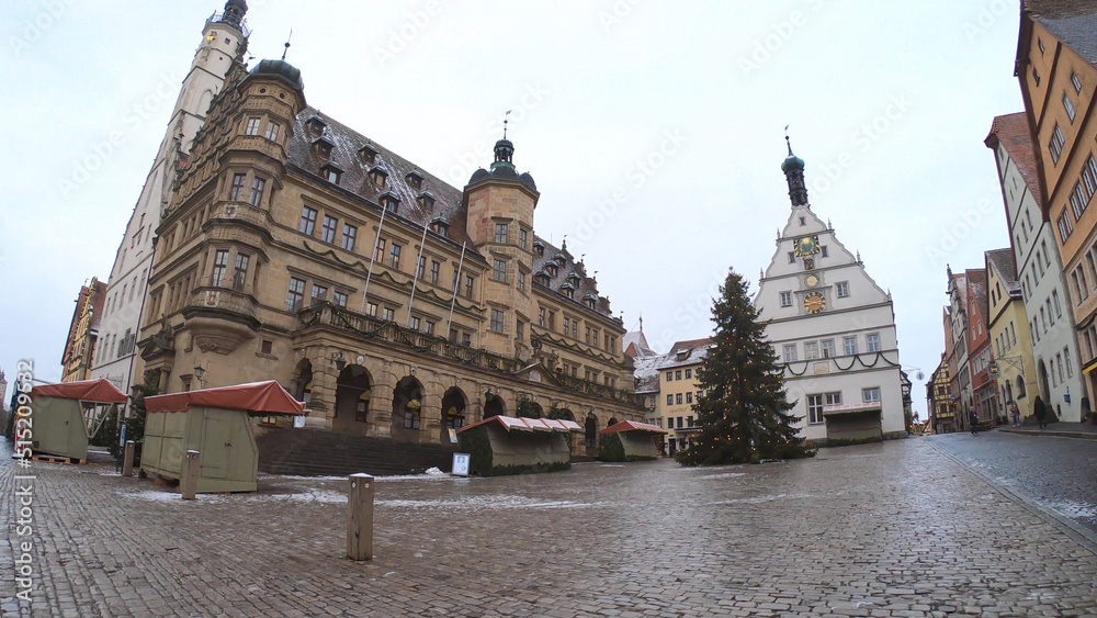 Rothenburg ob der Tauber, Germany, December 8, 2021: The Market Square and Town Hall Tower, with its grand stairs, the Renaissance façade and surrounded by the romantic timber-frame buildings.