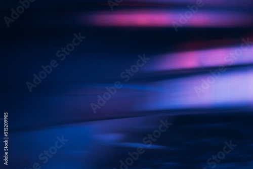 Blur light flare. Bokeh neon glow. Futuristic radiance. Defocused ultraviolet navy blue pink purple color flecks glare on dark modern abstract background. photo