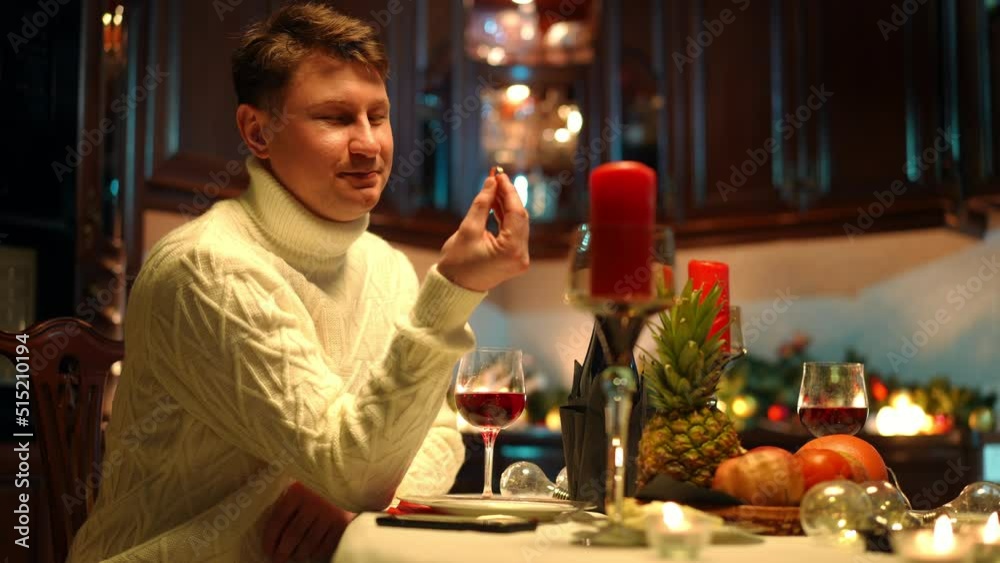 Thoughtful loving man taking out engagement ring from pocket admiring jewelry smiling. Portrait of happy relaxed Caucasian boyfriend preparing romantic dinner and proposal for partner indoors Thoughtful loving man taking out engagement ring from pocket admiring jewelry smiling. Portrait of happy relaxed Caucasian boyfriend preparing romantic dinner and proposal for partner indoors