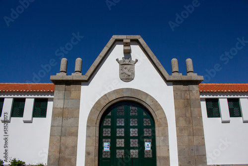Santo Tirso, Portugal, April 3, 2022: The Santo Tirso Municipal Market façade. The Coat of Arms of the city at the entrance.