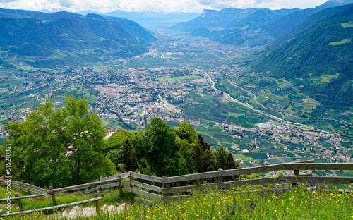  a hiking trail overlooking the alpine valley of the city Merano surrounded by the Texel group mountains (Oetztaler Alpen in Südtirol, South Tyrol, Italy)