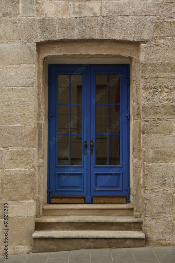 View of building with blue wooden door. Exterior design