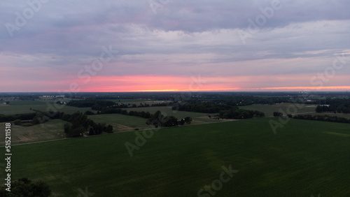 Sunset shot from drone overlooking fields and farming area of Indiana