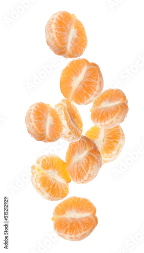 Tasty peeled tangerines falling on white background