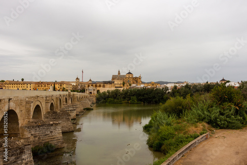 Cordoba  Spain  September 13  2021  Guadalquivir River and the Roman Bridge  with Cordoba Mosque-Cathedral in the background.