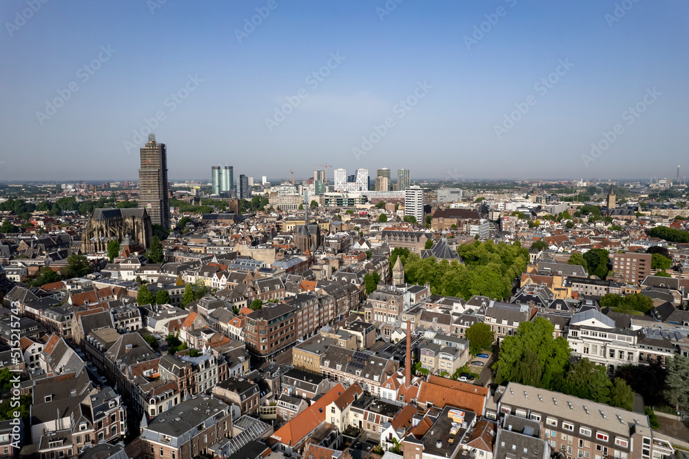 Aerial view medieval Dutch city centre of Utrecht with cathedral towering over the city lit up by early morning sunlight. Cityscape urban area in The Netherlands