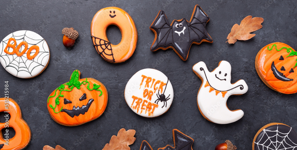 Fototapeta premium Trick OR Treat. Gingerbread cookies on dark stone background. Sweets for Halloween party