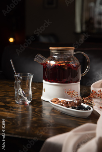 Oriental sweets and fruit tea on a wooden table with a dark background