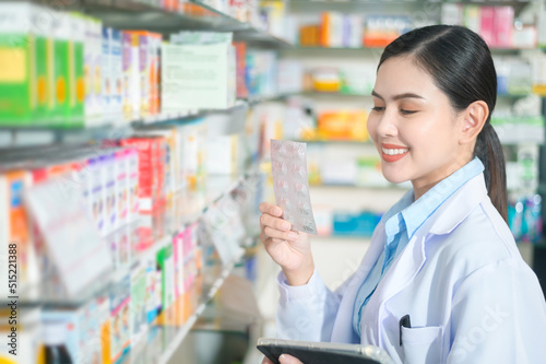 Portrait of female pharmacist using tablet in a modern pharmacy drugstore. Free Download Portrait of female pharmacist using tablet in a modern pharmacy drugstore. - GFXLoad