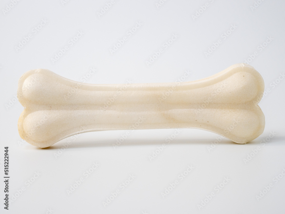 Pressed rawhide bone shaped dog chews. - obrazy, fototapety, plakaty 