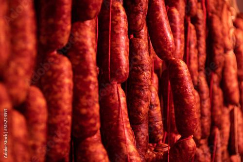 Drying red sausage. Spicy food with red paprika from the north of Spain. Selective focus.