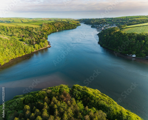 Aerial view looking down the river Lerryn above the treetops at sunset, Lostwithiel, Lerryn, Cornwall, United Kingdom. photo