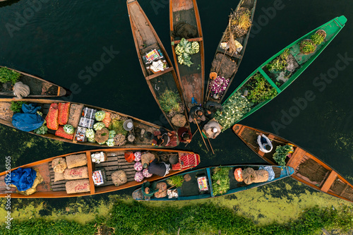 Aerial view of People on typical boats along the river during the floating market, Rainawari, Srinagar, Jammu and Kashmir, India. photo