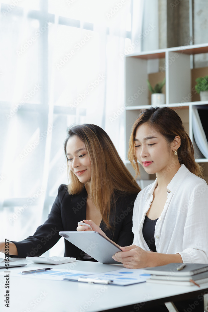 Atmosphere in the office of a startup company, two female employees are discussing, brainstorming ideas to working on summaries and marketing plans to increase sales and prepare reports to managers. Atmosphere in the office of a startup company, two female employees are discussing, brainstorming ideas to working on summaries and marketing plans to increase sales and prepare reports to managers.