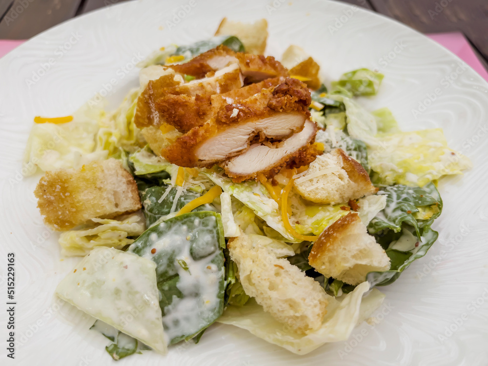 Caesar Salad with Chicken in White Dish 