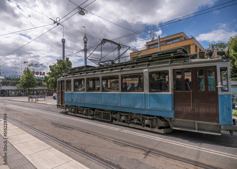Old tram type A1 in duty on the line in the island Djurgården at the stop ABBA museum and Tivoli, a sunny summer day in Stockholm