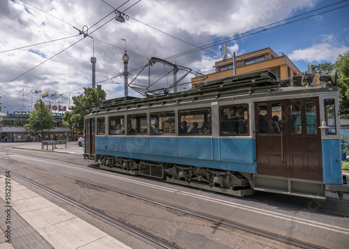 Old tram type A1 in duty on the line in the island Djurgården at the stop ABBA museum and Tivoli, a sunny summer day in Stockholm