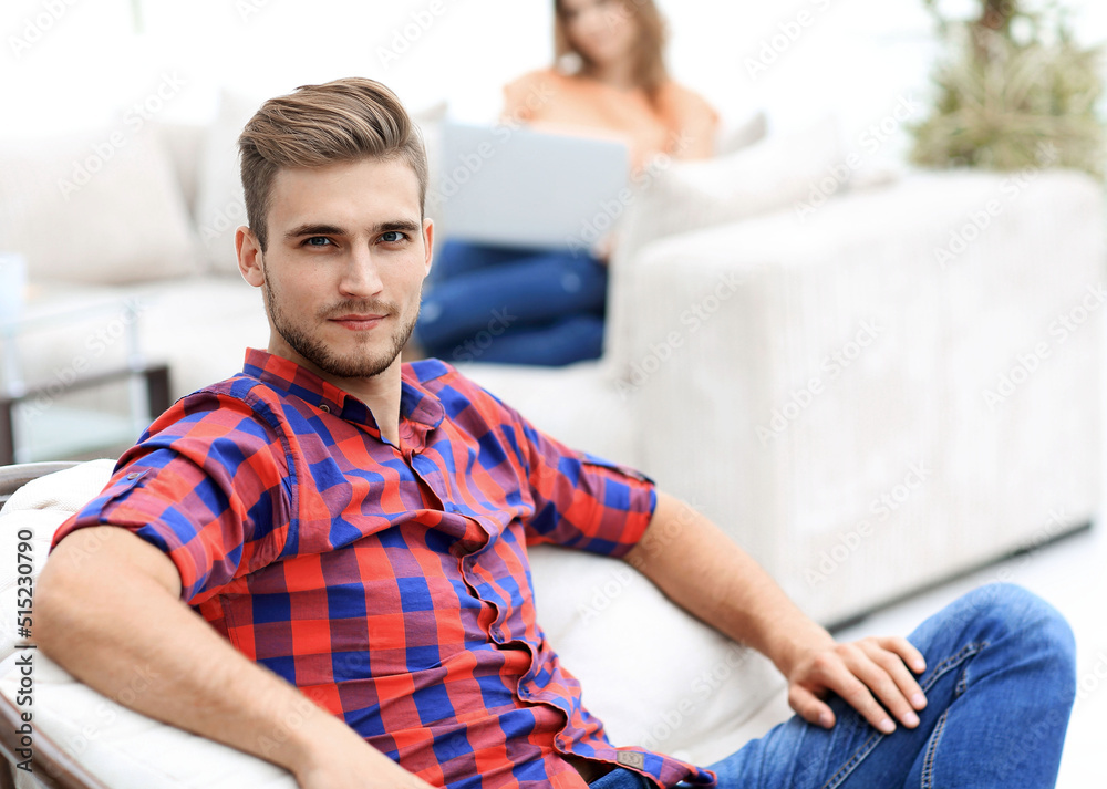 young man sitting in the big chair