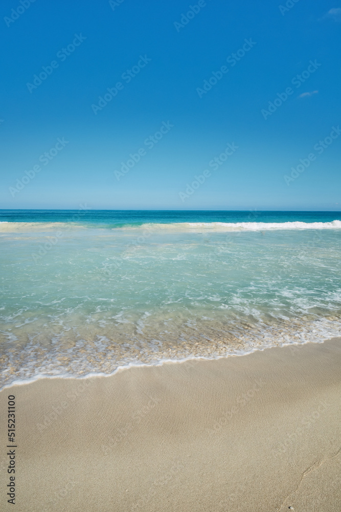 Ocean waves washing onto an empty beach shore in a tropical resort with clear blue sky and copyspace. Calm and peaceful landscape to enjoy in summer for a relaxing holiday abroad or vacation overseas