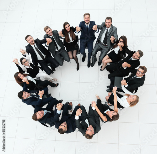 concept of team building.large business team sitting in a circle