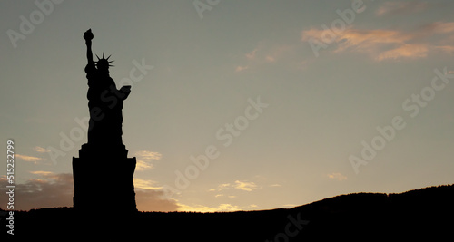 Silhouettes of The Statue of Liberty at sunset. Greeting card for Independence Day.