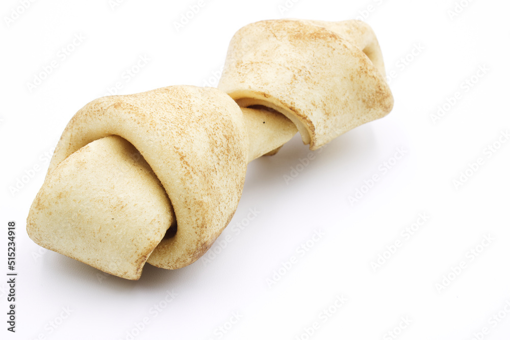 Carnaza bone for dogs to bite on, on a white background Carnaza bone for dogs to bite on, on a white background