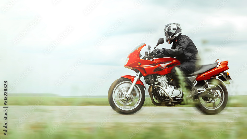 Motorcycle ride at high speed in the countryside, side view