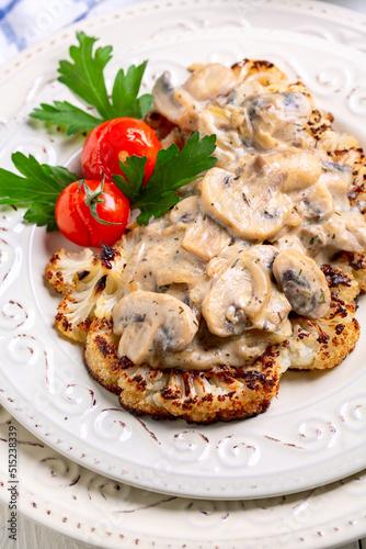 Cauliflower steak with mushrooms. Vegetarian cuisine.