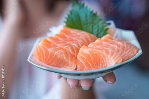 Japan raw salmon slice or salmon sashimi in japanese style. Salmon sasimi on hand.