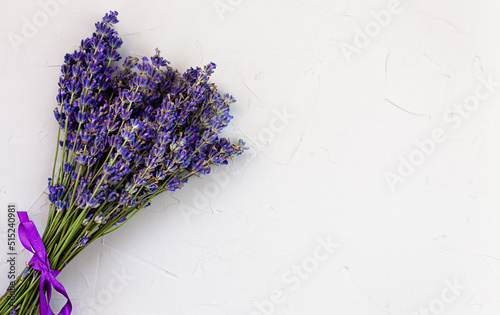 Lavender bouquet on a concrete gray background. Top view. Place for text. Selective focus.