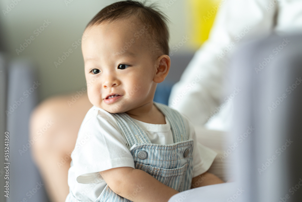 Father's Day concept, young Asian father holding a baby child with family person at home, happy childhood with love and care together, little cute son with dad and parent, parenthood lifestyle