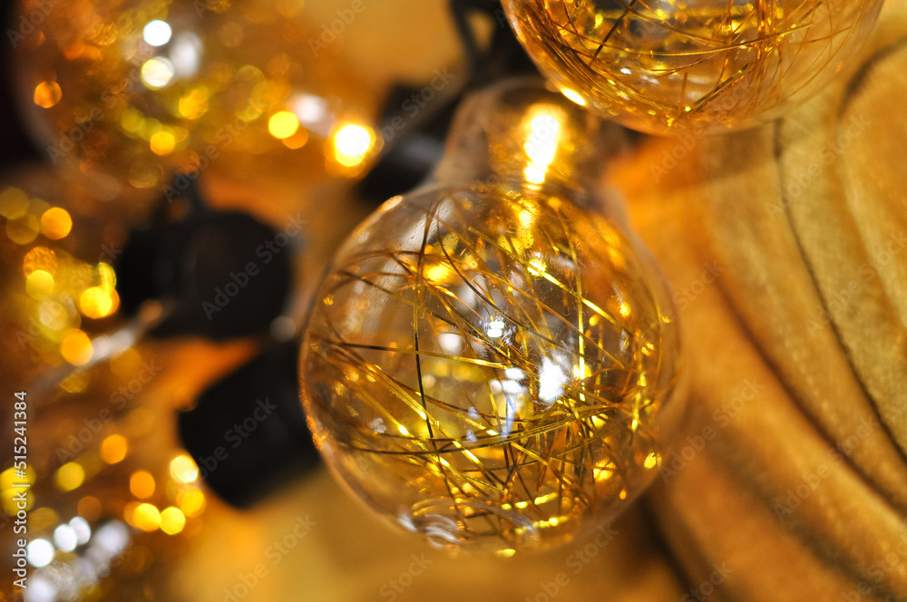sparkling gold christmas garland with lights on the arm chair