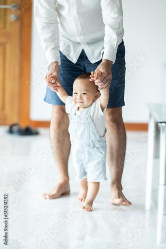 Obraz na plátne toddler baby learning to walk and having support by family together, little chil