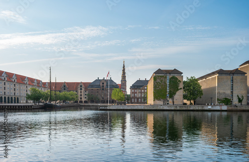 Copenhagen, Denmark. Cityscape with brick historical buildings on the embankment and tower of the Church of our Saviour (Stairway to Heaven).