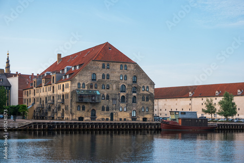 Copenhagen, Denmark. Historic building with a moored boat on the waterfront of the Danish capital.