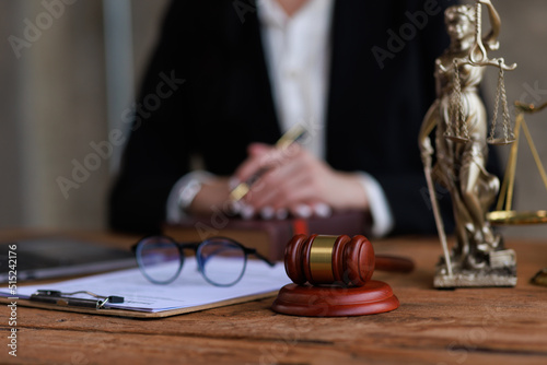 justice and law concept.a female judge in a courtroom on a wooden table and a Counselor or female lawyer working in an office. Legal law, advice, and justice concept.