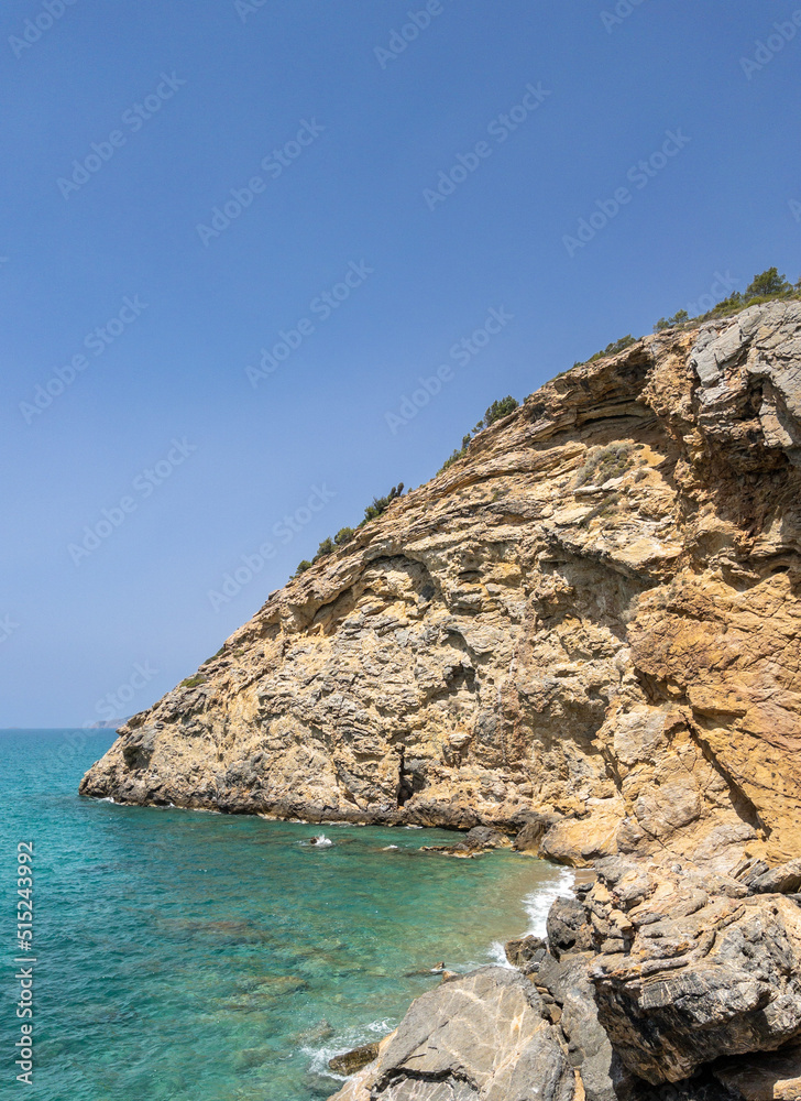 Clean clear sea water. Coast of the Mediterranean Sea. Rocks. The splash of waves on the rock. 