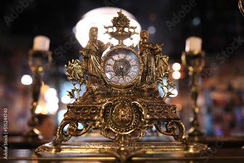 Gilded antique clock on table