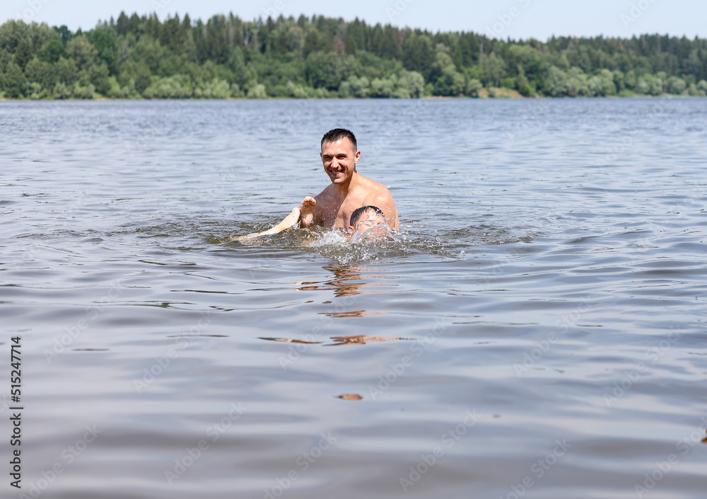 father and son swim together in a river pond