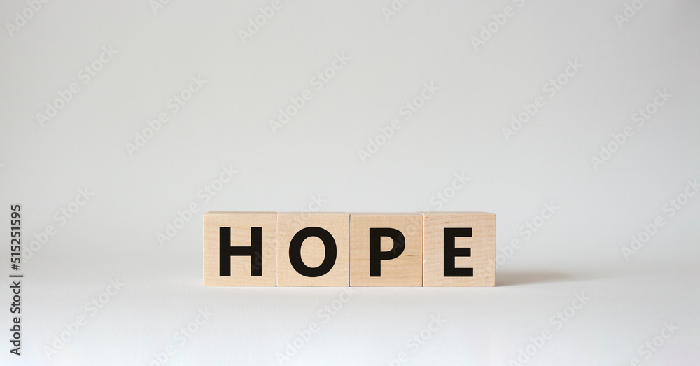 Hope symbol. Concept word Hope on wooden cubes. Beautiful white background. Business and Hope concept. Copy space.