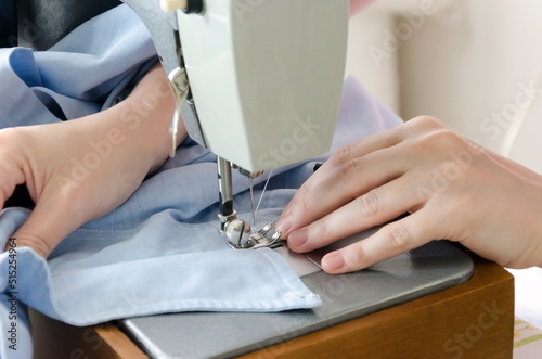Sewing striped shirt on a sewing machine.   lose up