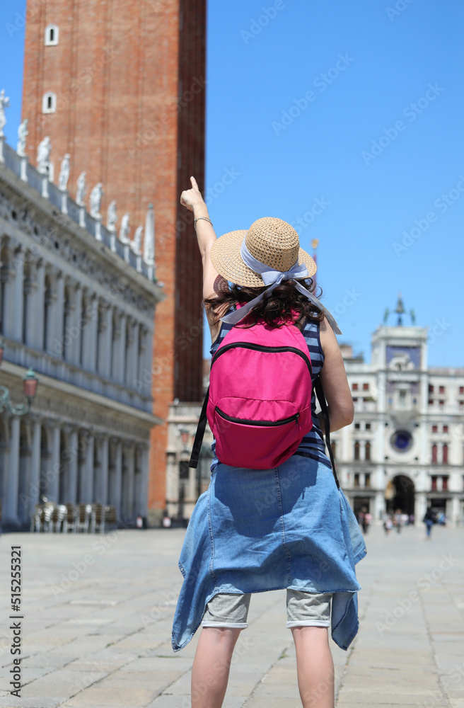 woman with backpack and the boater straw hat in Venice