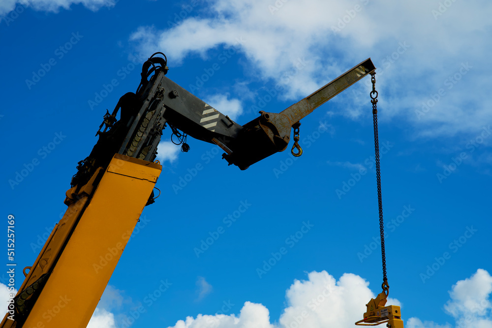 Close up of a yellow crane lifting goods Close up of a yellow crane lifting goods