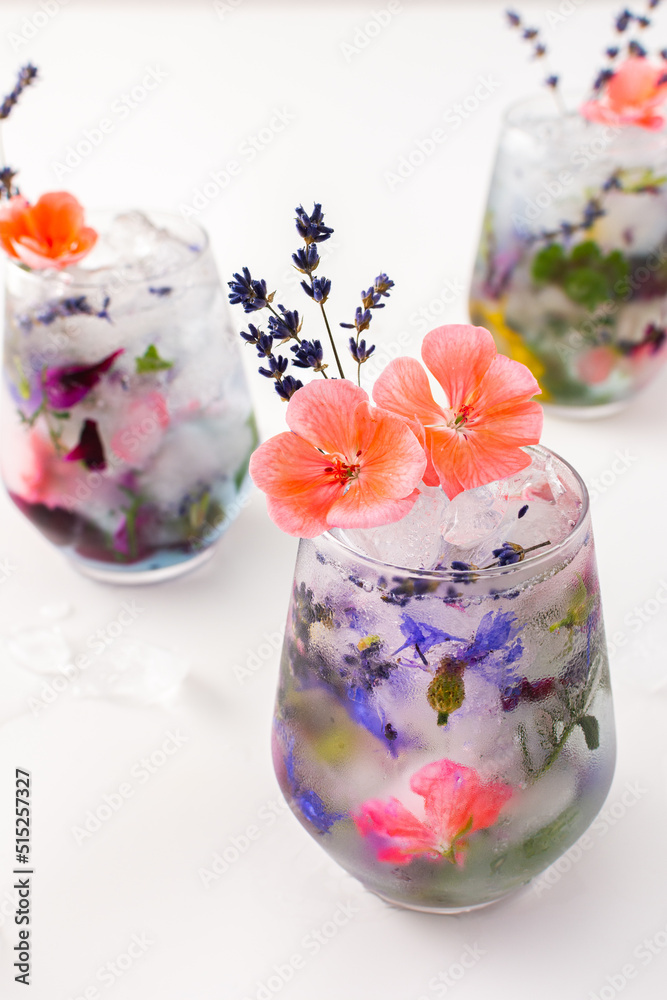 Refreshing cold drink with frozen flowers, cornflowers and geraniums, osteosperum and lavender and carnation Refreshing cold drink with frozen flowers, cornflowers and geraniums, osteosperum and lavender and carnation