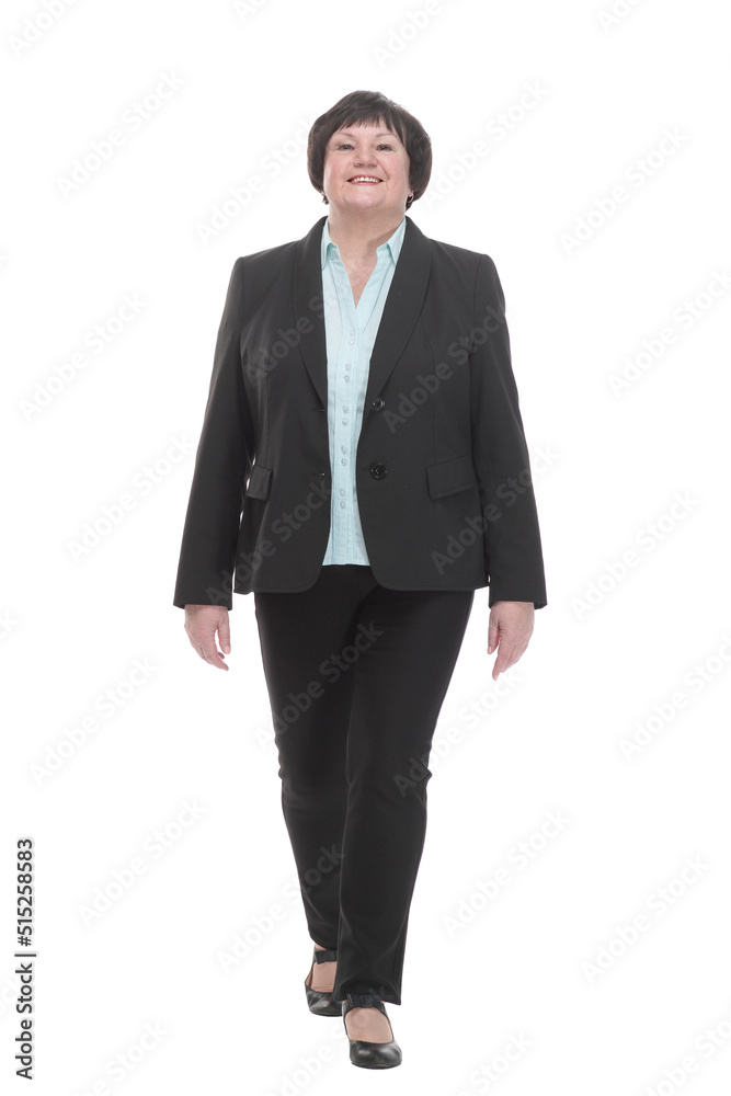Mature business woman in a pantsuit striding forward. Mature business woman in a pantsuit striding forward.