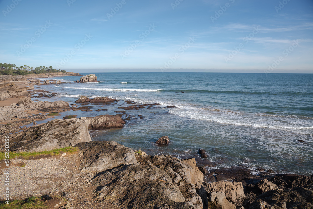 Beautiful scenic view of a rocky beach on a day with blue sky, Noja, Cantabria, Spain Beautiful scenic view of a rocky beach on a day with blue sky, Noja, Cantabria, Spain