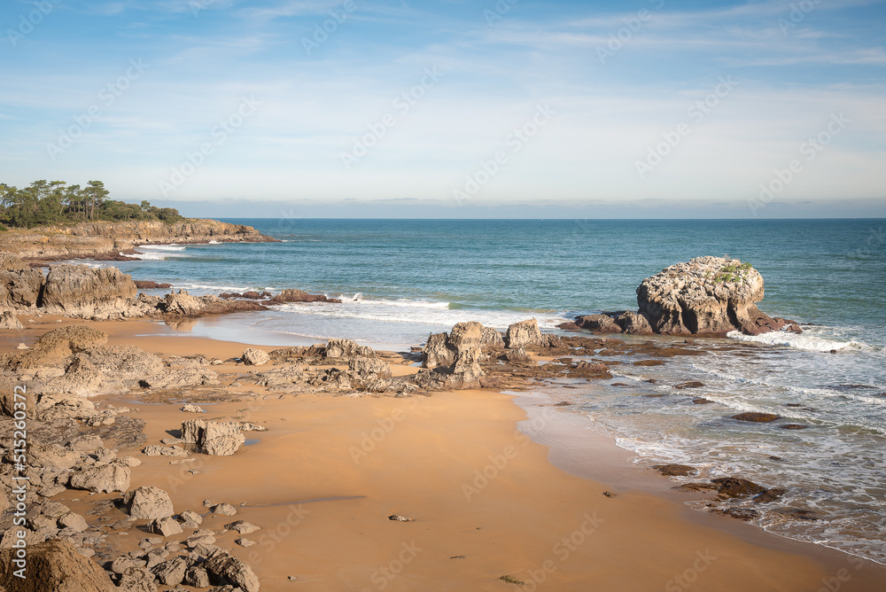 Beautiful scenic view of a rocky beach on a day with blue sky and clouds, Noja, Cantabria, Spain Beautiful scenic view of a rocky beach on a day with blue sky and clouds, Noja, Cantabria, Spain